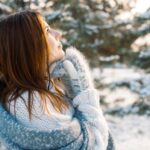 Women looks into the sun on a winters day to battle seasonal affective disorder