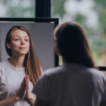 Woman looking at herself in the mirror