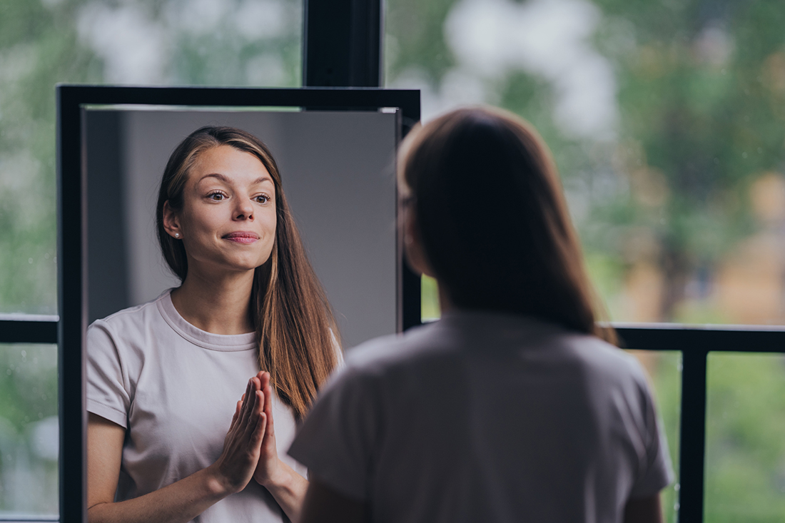 Woman looking at herself in the mirror