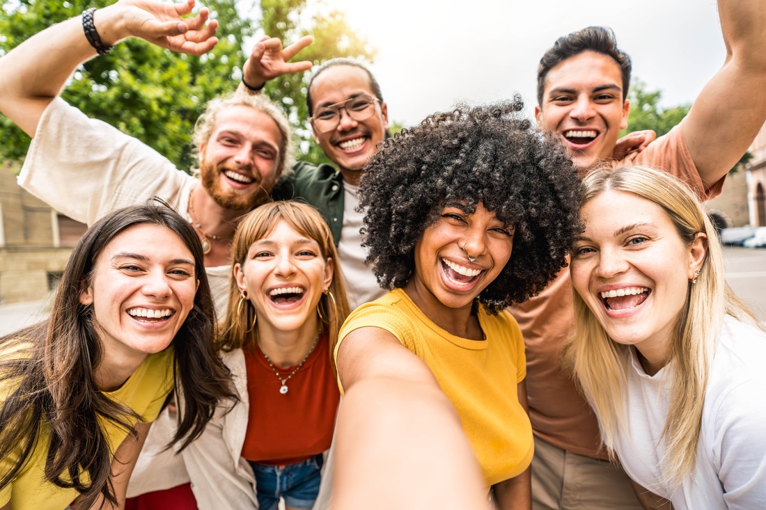 a group of multicultural friends taking a selfie