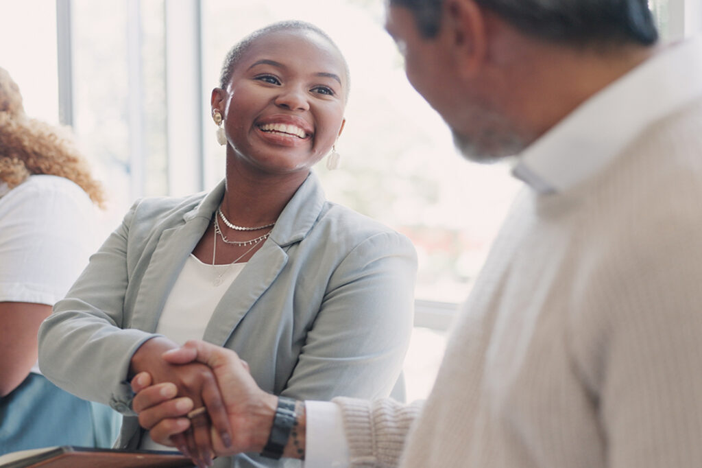 African-American woman shaking a colleague's hand