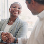 African-American woman shaking a colleague's hand