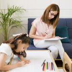 Child and woman engaging in parallel play