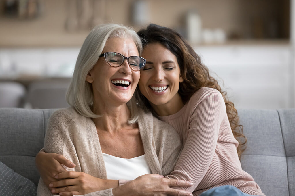 Two women hugging and smiling