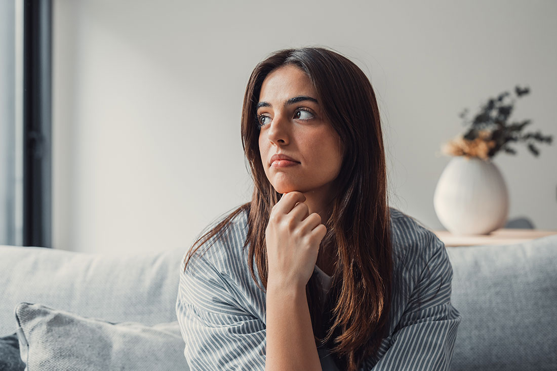 Close up of sad pensive woman sitting alone