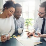 A young couple learning from a financial coach