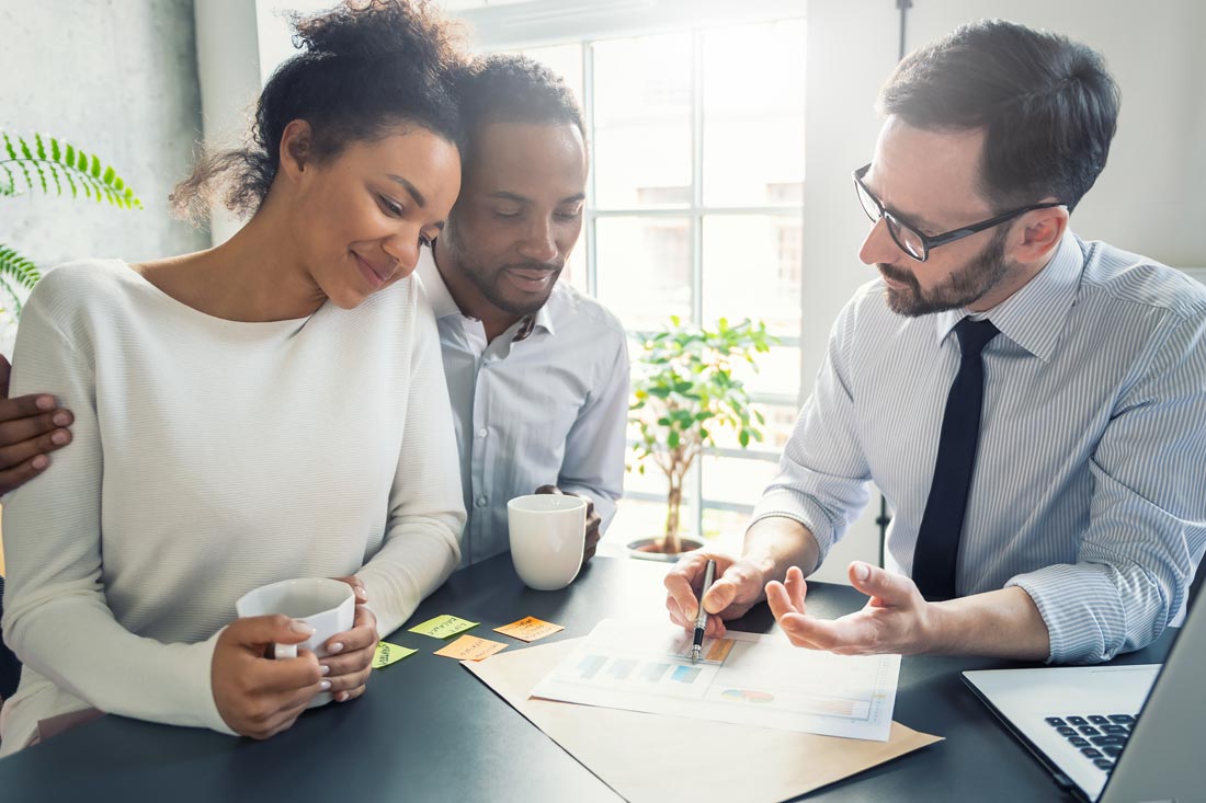 A young couple learning from a financial coach