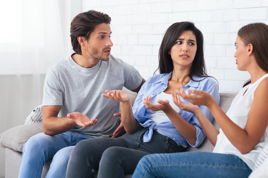 Two friends arguing and a friendship coach mediating