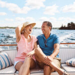 A laughing, happy couple on a boat for retirement