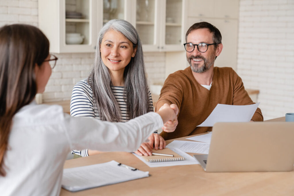 middle age couple successfully learning how to negotiate with debt collectors