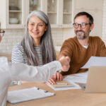 middle age couple successfully learning how to negotiate with debt collectors