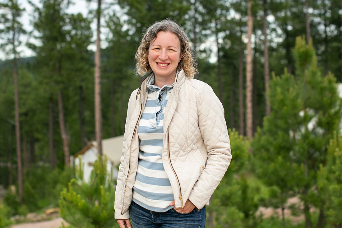 sarah dusek standing with trees in backdrop