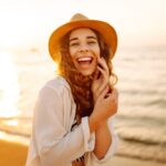 a woman smiling at the beach