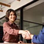 Woman shaking hands at an AI job interview