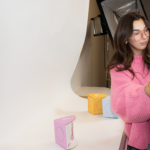 An influencer setting up lighting in front of a blank wall