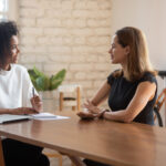 Two women speaking during an exit interview