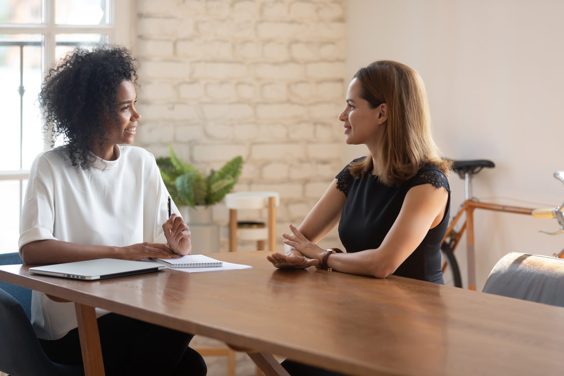 Two women speaking during an exit interview